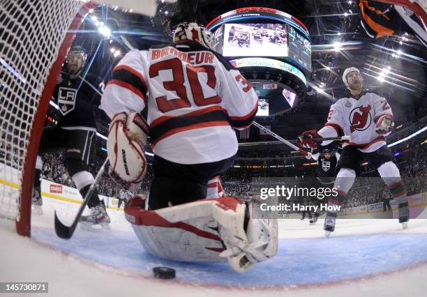 Trevor Lewis of the Los Angeles Kings and David Clarkson of the New Jersey Devils react after the puck goes into the net for a goal in Game Three of...