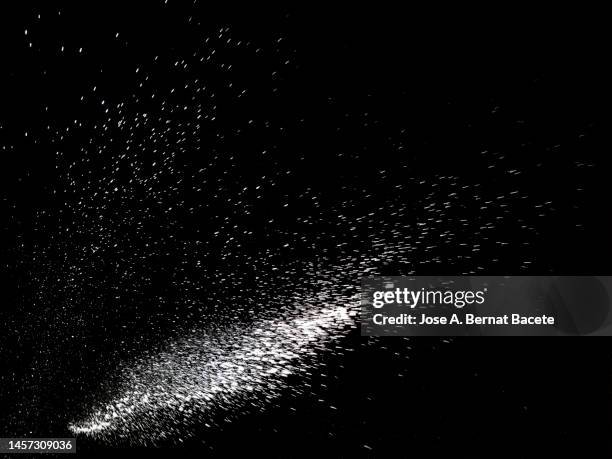 shock wave from an explosion of dust and smoke on a black background. - dust foto e immagini stock