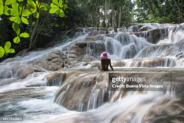 young woman in a waterfall - dunns river falls stock pictures, royalty-free photos & images