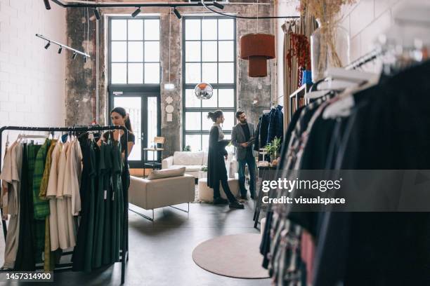 shopping in modern boutique - clothes shop stock pictures, royalty-free photos & images