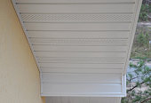 Plastic white uPVC soffit board below the facia of the roof.