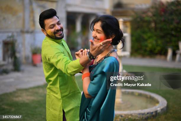 indian couple enjoying holi festival in the courtyard of a palace in rajasthan - holi festival and indian person stock pictures, royalty-free photos & images