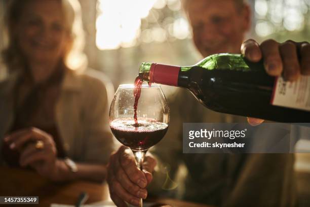 pouring wine during a meal! - wine bottle stock pictures, royalty-free photos & images