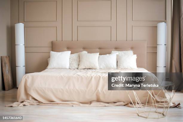 bed with bedding in beige tones. bedroom. interior. design. bright room. modern house design. - headboard ストックフォトと画像