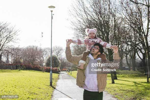 sitting on daddys shoulders - adoption family stock pictures, royalty-free photos & images