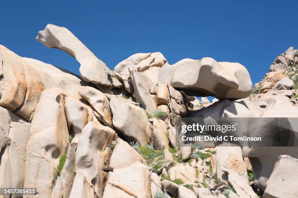 huge granite boulders clinging to hillside above the strait of bonifacio, capo testa, santa teresa di gallura, sassari, sardinia, italy - david cliff stock pictures, royalty-free photos & images