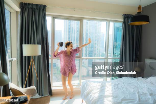 mujer bailando por la mañana mientras toma café - emirati dance fotografías e imágenes de stock