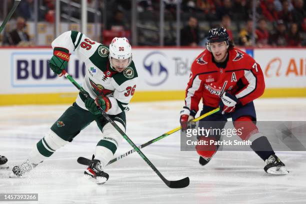 Mats Zuccarello of the Minnesota Wild and T.J. Oshie of the Washington Capitals skate during the second period at Capital One Arena on January 17,...