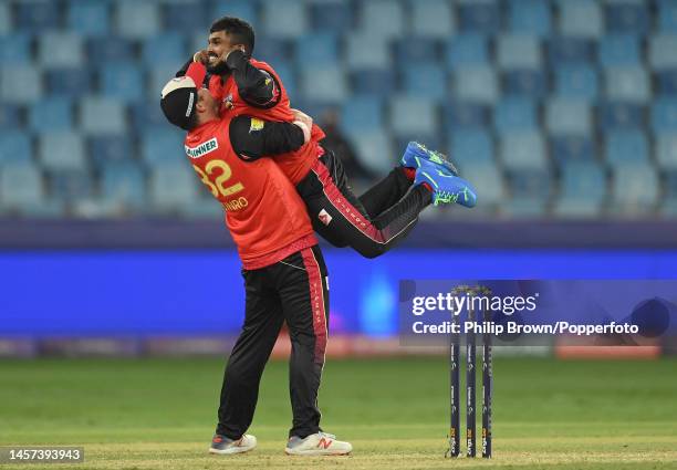 Wanindu Hasaranga de Silva of Desert Vipers is held in the air by Colin Munro after dismissing Andre Russellduring the Desert Vipers and Abu Dhabi...