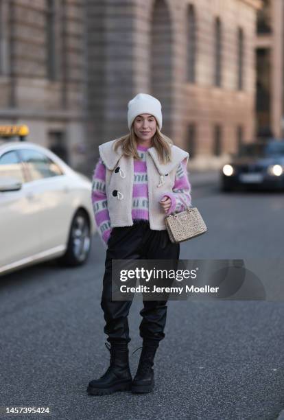 Sonia Lyson seen wearing Zara black leather pants, a Miu Miu pink white logo sweater, Copenhagen Studios black leather boots, a Prada Galleria gold...