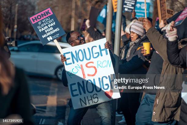 Healthcare worker holds a placard during a rally outside St George's University of London, Jan. 18 in London, United Kingdom. The walkouts today and...