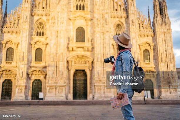 young female tourist taking a picture of cathedral in milan - tourist camera stock pictures, royalty-free photos & images