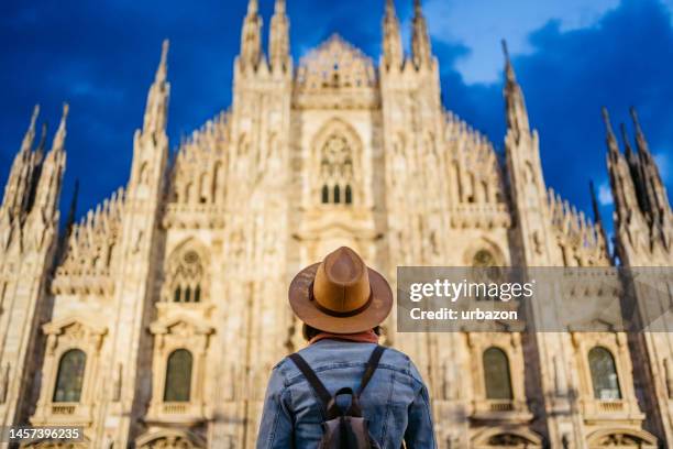 young female tourist enjoying the view of cathedral in milan - milan landmark stock pictures, royalty-free photos & images