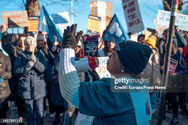 Healthcare worker holds a microphone during a rally outside St George's University of London, Jan. 18 in London, United Kingdom. The walkouts today...