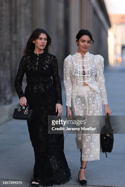 Giannina Haupt and Alyssa Cordes seen wearing total Dior looks with black and white transparent dresses and matching bags and shoes during the Berlin...