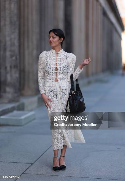 Alyssa Cordes seen wearing a total Dior look with a white transparent long dress, black heels and a black bag during the Berlin Fashion Week AW23 on...