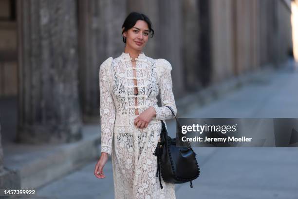 Alyssa Cordes seen wearing a total Dior look with a white transparent long dress, black heels and a black bag during the Berlin Fashion Week AW23 on...