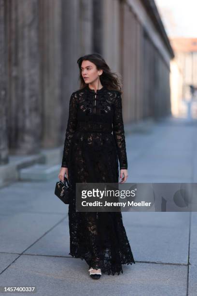 Giannina Haupt seen wearing a total Dior look with a black transparent dress, white and black heels and a black leather bag during the Berlin Fashion...