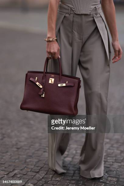 Rebecca Mir seen wearing a Hermes Bordeaux Birkin leather 40, Sportmax shoes, Pomellato yellow gold jewelry and a Guiseppe di Morabito off shoulder...