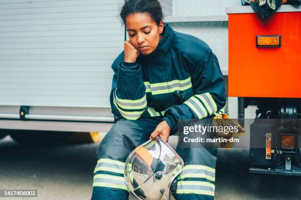 depressed firefighter after rescue operation - black firefighter stock pictures, royalty-free photos & images