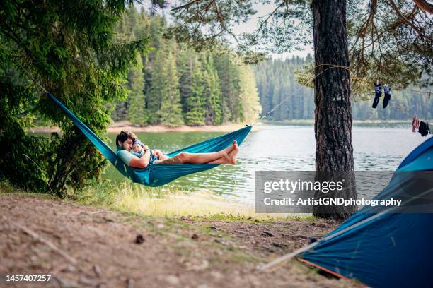 daddy and me on a hammock. - hammock camping stock pictures, royalty-free photos & images