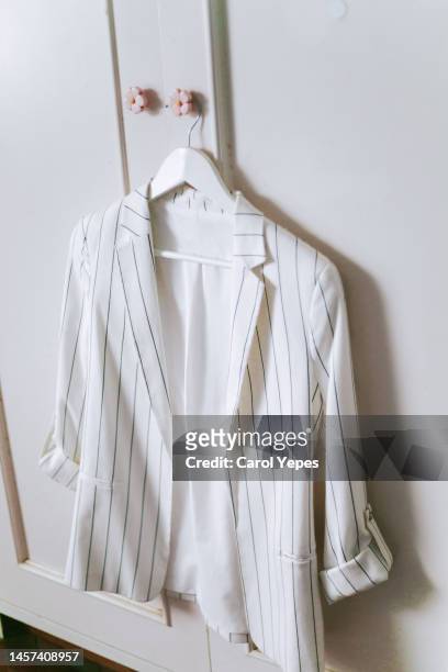 striped white coat on hanger at home - white coat fashion item stock pictures, royalty-free photos & images