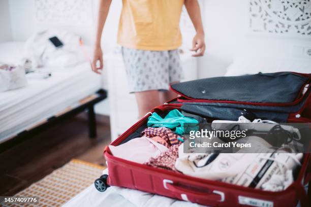 teenager boy  packing luggage for  holidays in his bedroom - teen packing suitcase stock pictures, royalty-free photos & images