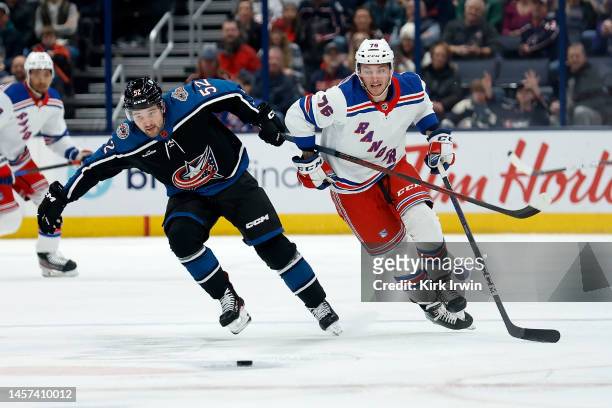 Emil Bemstrom of the Columbus Blue Jackets and Jonny Brodzinski of the New York Rangers chase after the puck during the game at Nationwide Arena on...