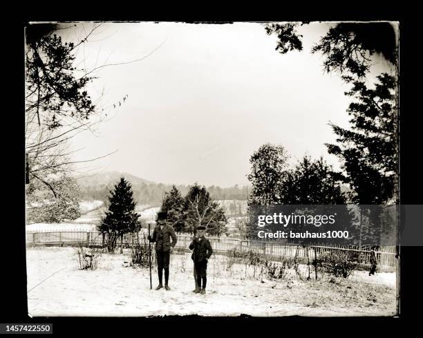 portrait of two boys in the snow, circa 1890 - front lawn stock illustrations