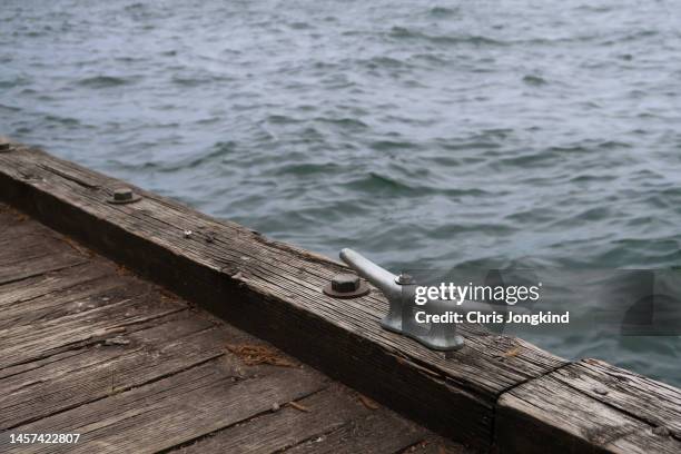 dock cleat on wooden dock on waterfront - lake ontario stock pictures, royalty-free photos & images