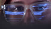 Close Up Eyes Of Coder Focused On Screen While Coding Data Flashes In ...