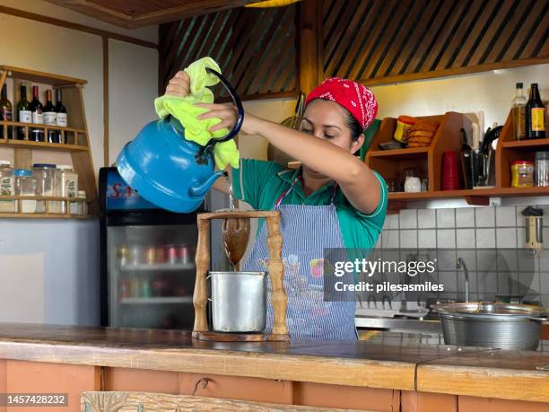 traditional coffee brewing through muslin filter, hillside cafe, santa juana reserve, puntarenas province, costa rica. - costa rica coffee stock pictures, royalty-free photos & images