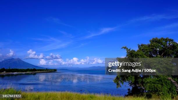 scenic view of lake against blue sky,lembata regency,east nusa tenggara,indonesia - lembata stock pictures, royalty-free photos & images