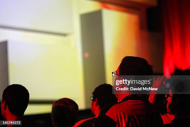 Audience members are illuminated by the demonstration of a new game at the Sony 'press conference' on the eve of the Electronic Entertainment Expo on...