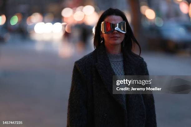 Amelie Stanescu wearing big flashy shades, grey long coat, grey knitted sweater during the Berlin Fashion Week AW23 on January 16, 2023 in Berlin,...