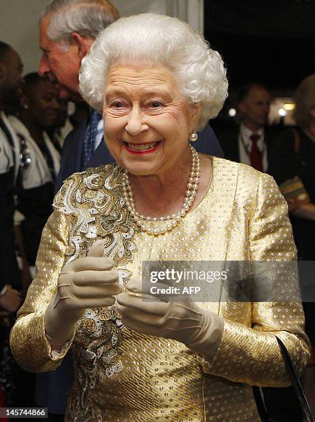 Queen Elizabeth II greets performers backstage during the Diamond Jubilee Concert outside Buckingham Palace in London, on June 4, 20112.The...