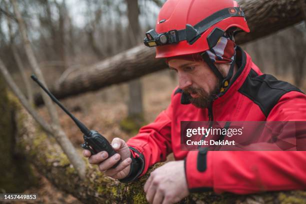 rescatista serio en uniforme usa un walkie-talkie - perro de búsqueda y rescate fotografías e imágenes de stock