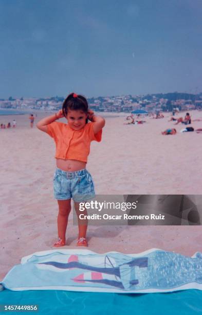 girl enjoying the beach on vacation - children vintage coastal stock-fotos und bilder