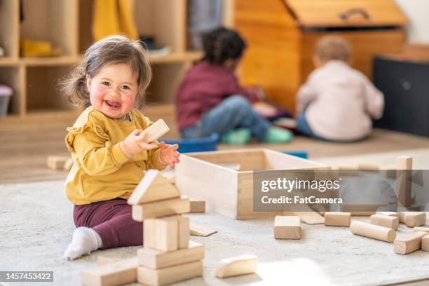 little girl playing with blocks - small smart girl stock pictures, royalty-free photos & images