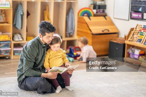 story time at daycare - baby imagination stock pictures, royalty-free photos & images