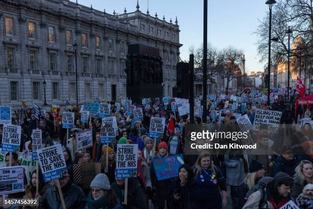 Nursing staff and supporters march down Whitehall to Downing Street during a day of strikes, on January 18, 2023 in London, United Kingdom. Members...