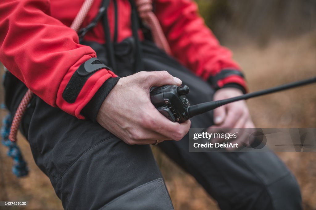 Close-up shot of the walkie-talkie that the rescuer is holding in his hand