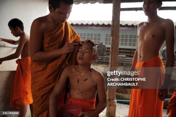 Thailand-religion-society-gender" by Janesara FUGAL This picture taken on June 15, 2011 shows Buddhist novice monk and aspiring ladyboy Pipop...