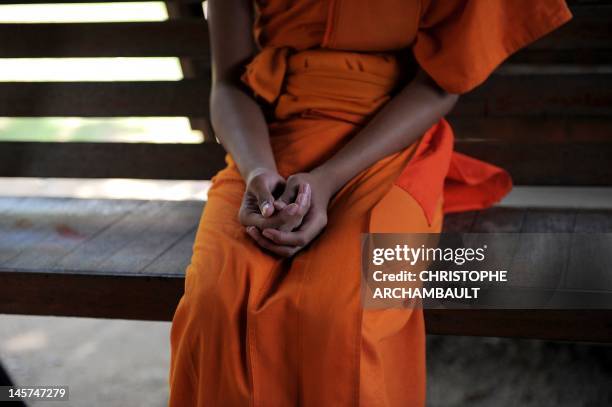 Thailand-religion-society-gender" by Janesara FUGAL This picture taken on June 16, 2011 shows Buddhist novice monk and aspiring ladyboy Pipop...