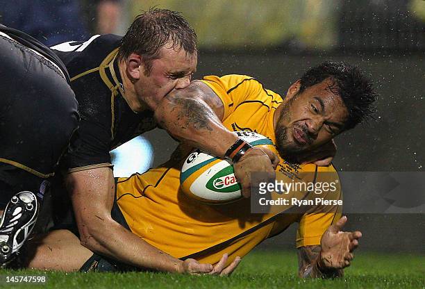 Digby Ioane of Australia is tackled by Alasdair Kellock of Scotland during the International Test match between the Australian Wallabies and Scotland...