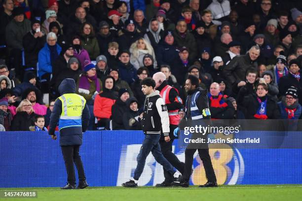 Pitch invader is escorted off the pitch by Stewards during the Premier League match between Crystal Palace and Manchester United at Selhurst Park on...