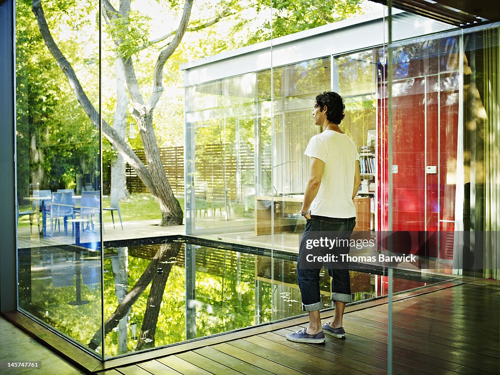 Man standing in hallway of modern home