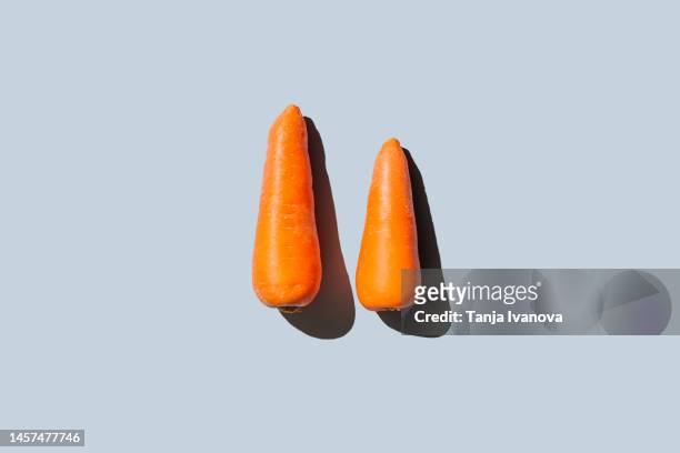 creative layout of carrot on blue background. vegetable pattern. healthy food, diet and detox concept. flat lay, top view - carrot isolated stock pictures, royalty-free photos & images