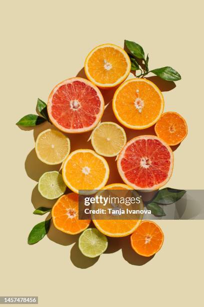 pattern of slices citrus-fruit of lemons, oranges, grapefruit, lime on beige background. healthy food, diet and detox concept. flat lay, top view - lemon lime top stock pictures, royalty-free photos & images