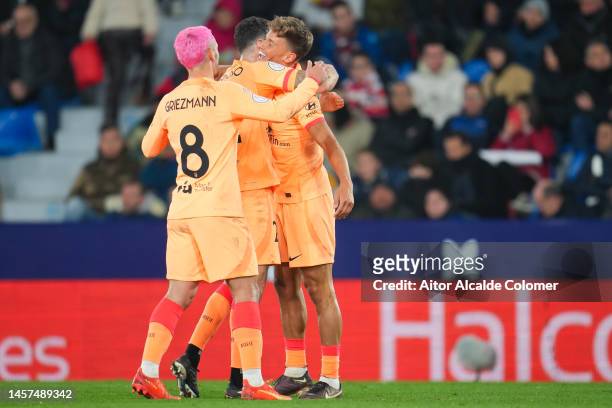 Marcos Llorente of Atletico de Madrid celebrates scoring his side's 2nd goal with Mario Hermoso and Antoine Griezmann of Atletico de Madrid during...